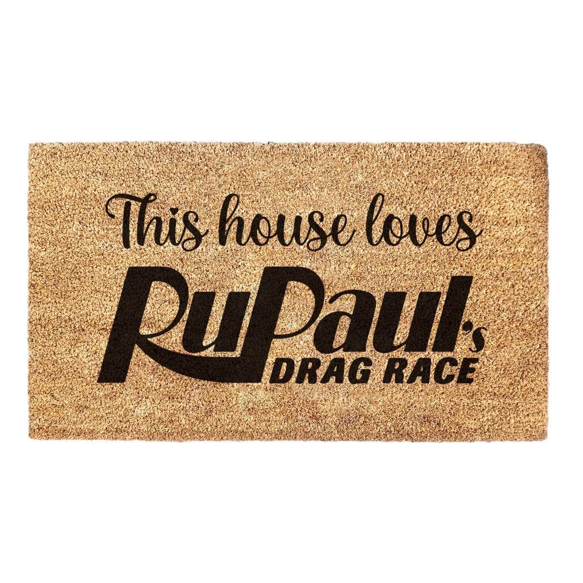 Coir welcome mat with 'This house loves RuPaul's Drag Race' printed on it.