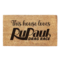 Thumbnail for Coir welcome mat with 'This house loves RuPaul's Drag Race' printed on it.