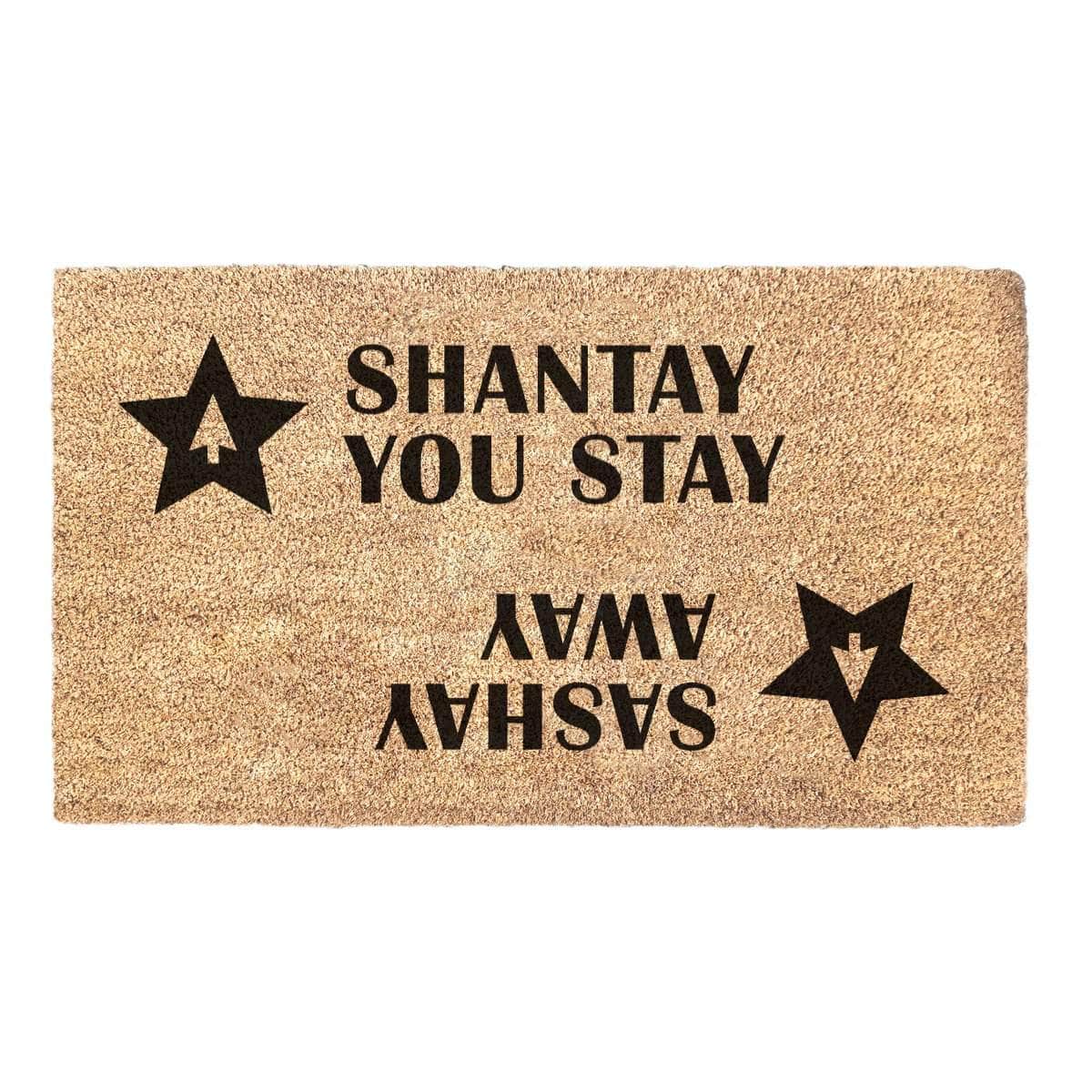 Coir doormat with two stars and a RuPaul saying 'Shantay you stay, Sashay Away' printed on in it with black ink