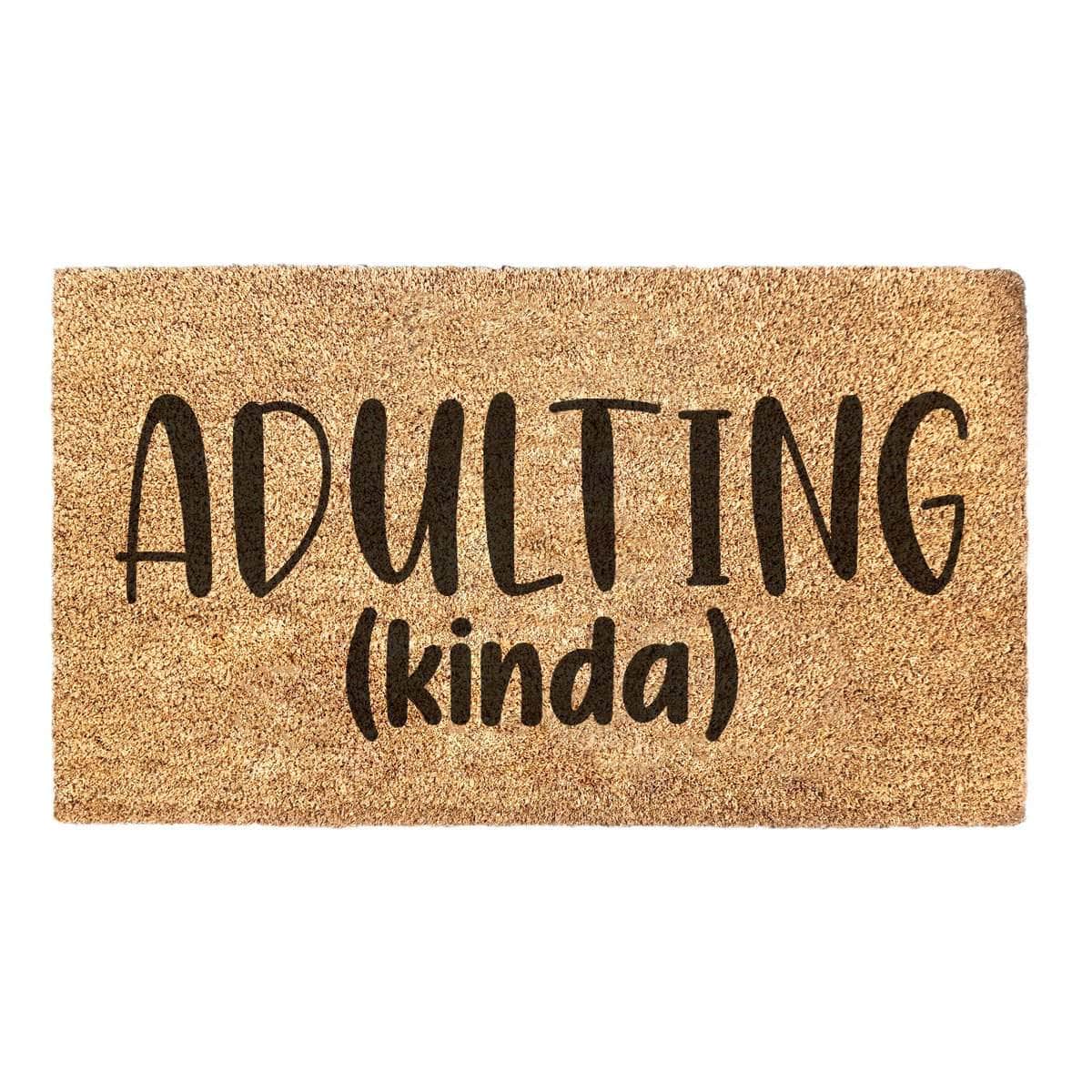 Doormat with the words 'Adulting (kinda)' on it.